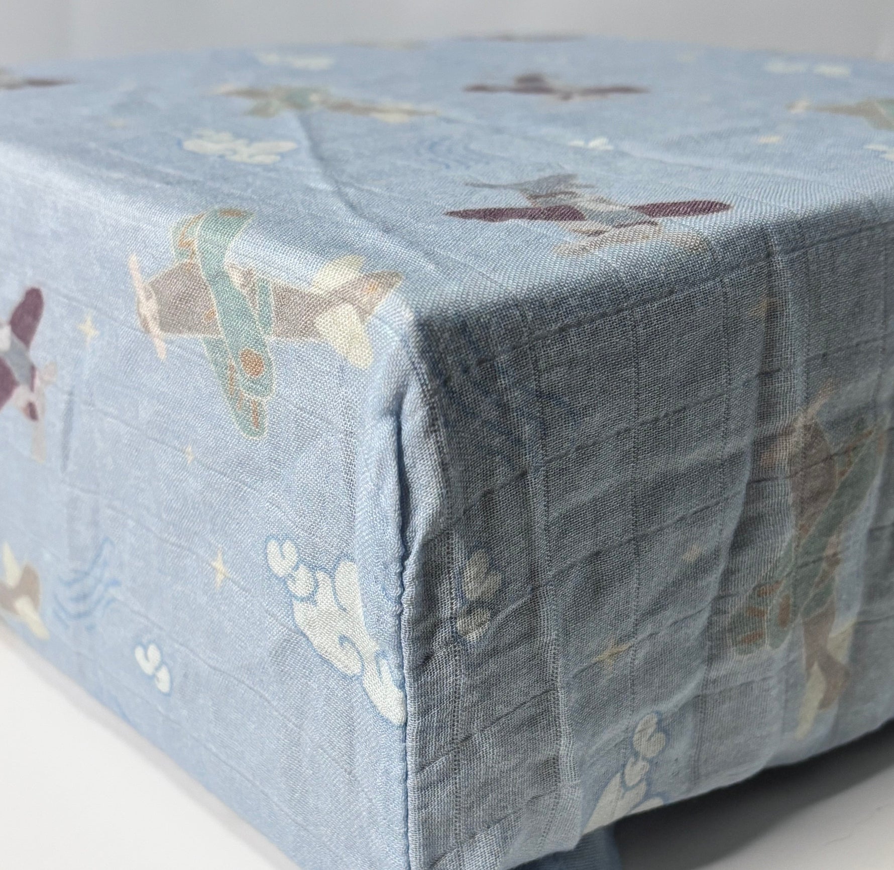 Cotton Bamboo Muslin crib sheet with adorable planes using pastel blue hues and natural colors