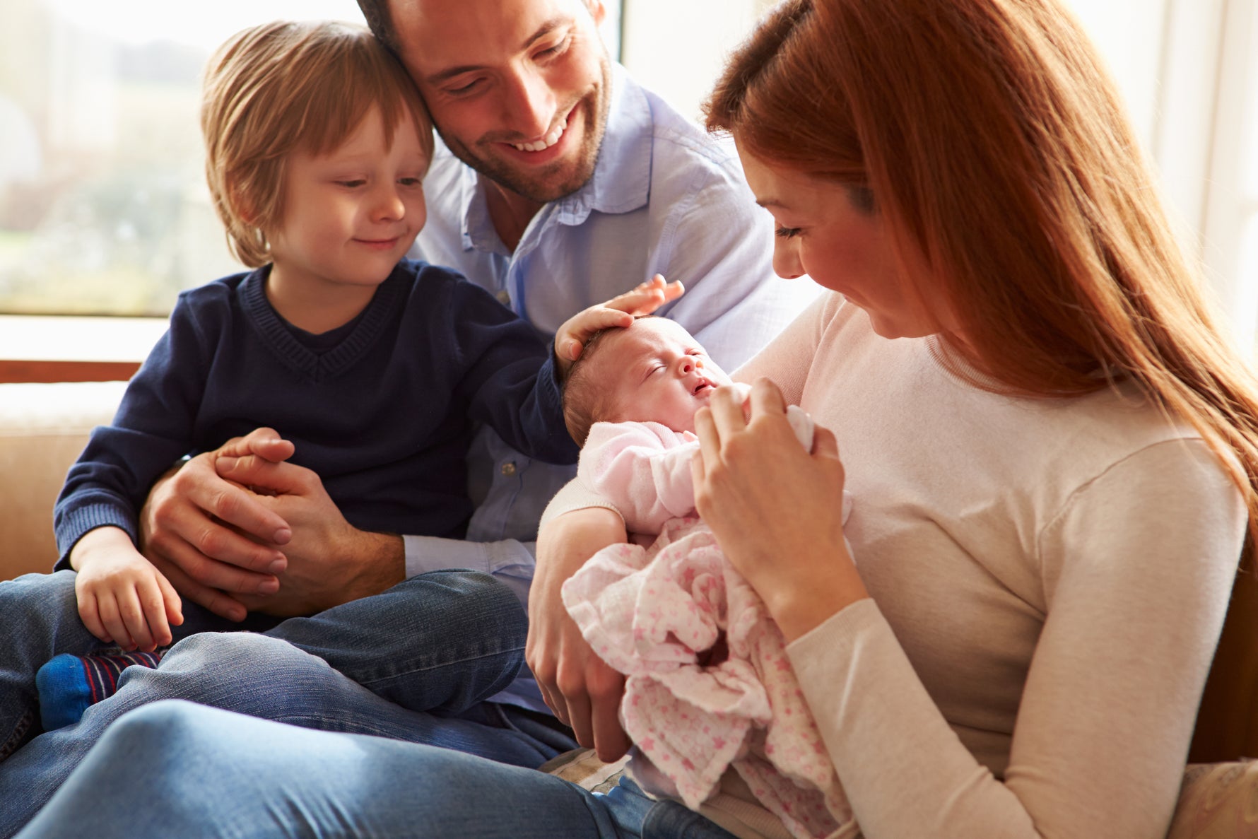 family of four mother holding newborn