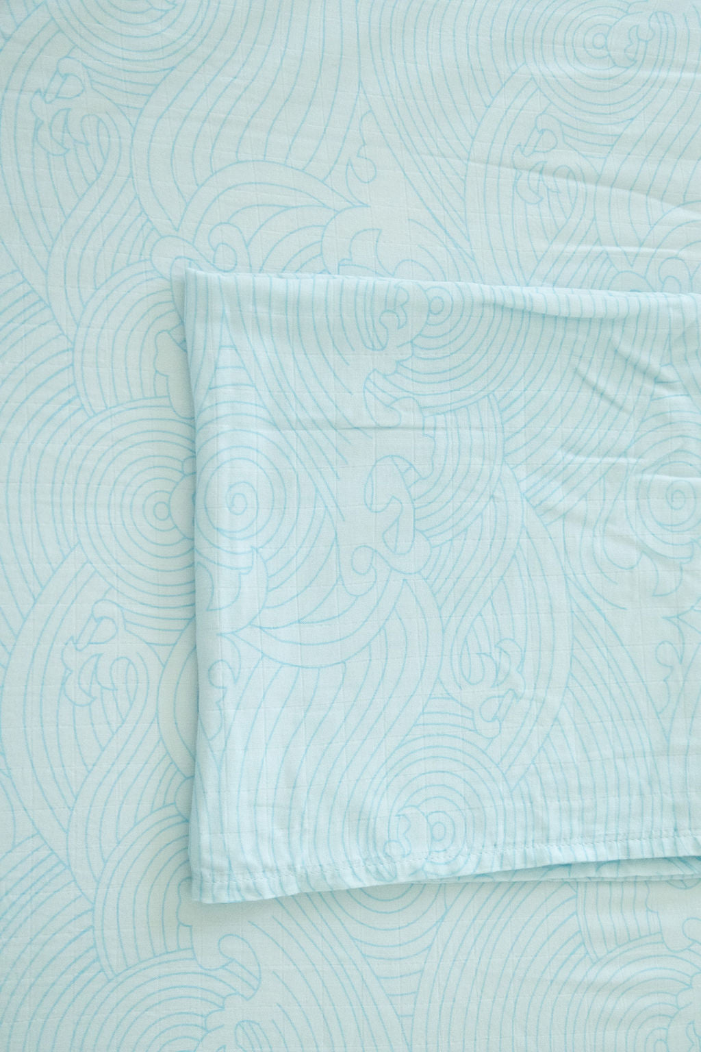 Light blue textured fabric with a folded corner
