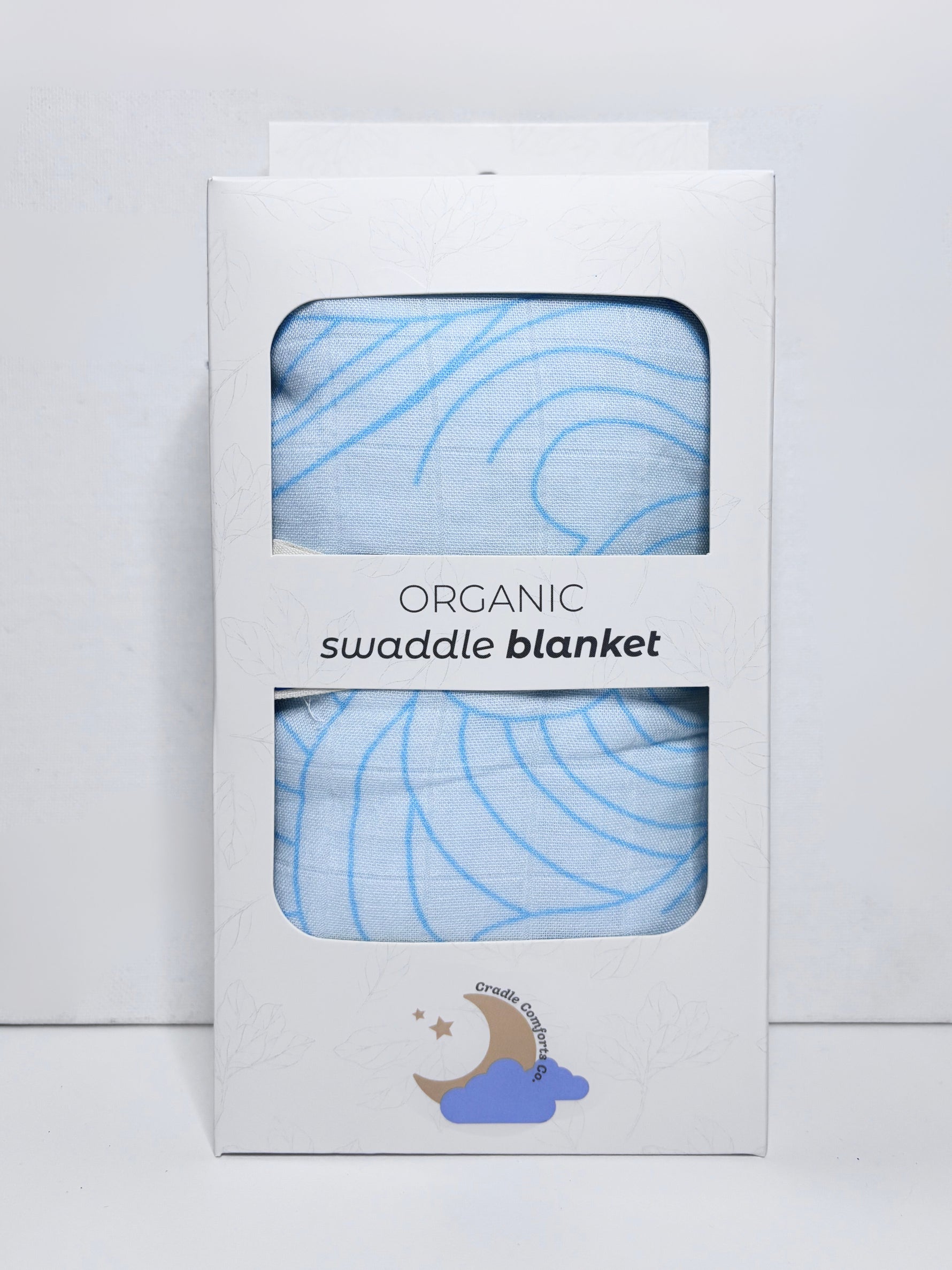 Organic swaddle blanket in packaging with blue pattern on a light gray background