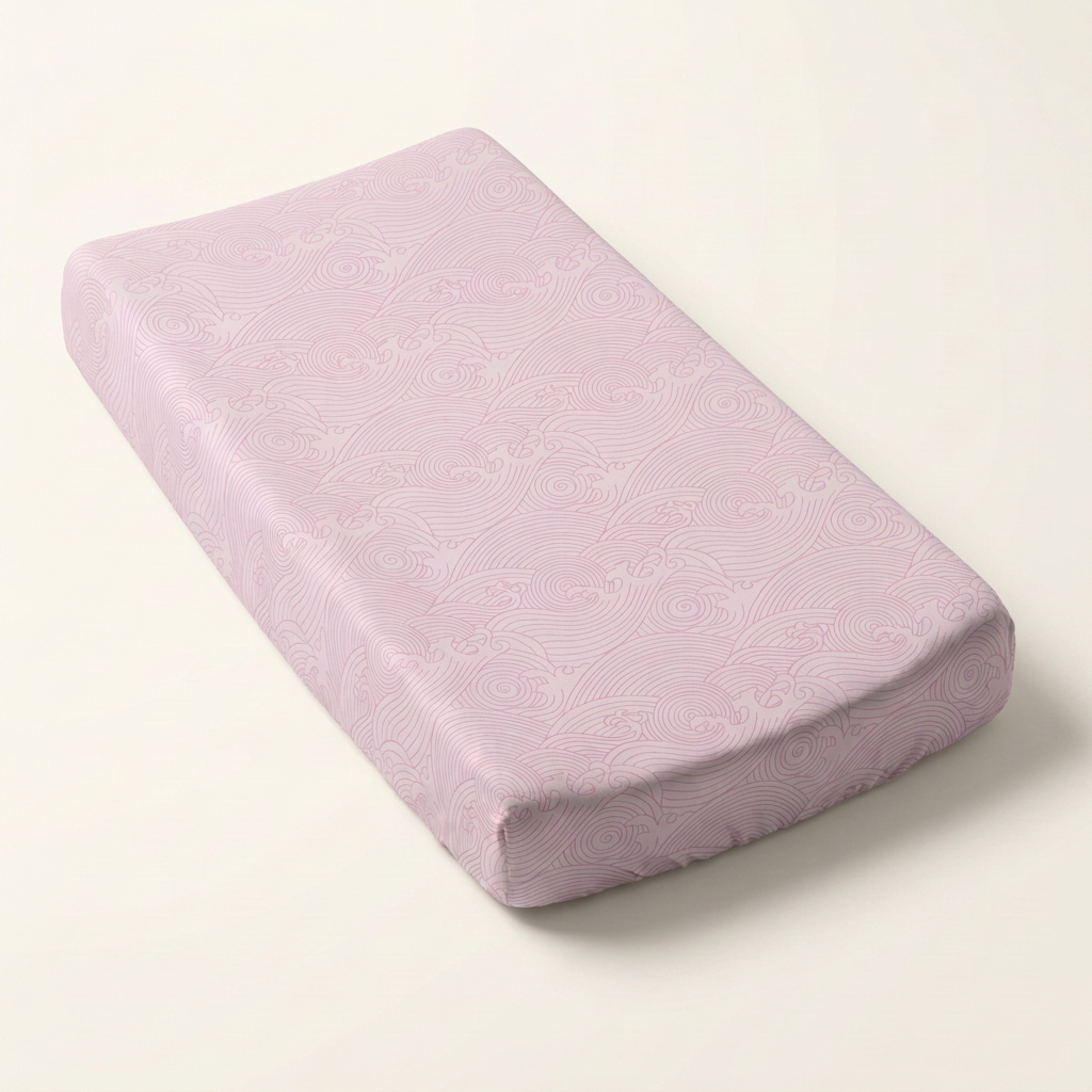 Pink Crashing Sea Waves changing pad cover on a long rectangular changing pad against a clean background
